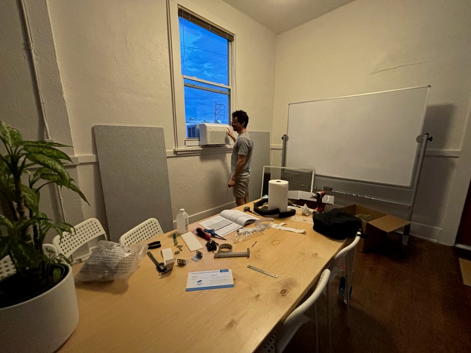 Ivan pressing a button on a window AC