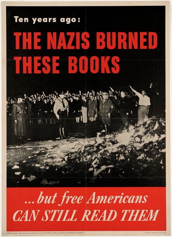 Photograph of crowd of people giving the Nazi salute while three soldiers stand over a burning pile of books