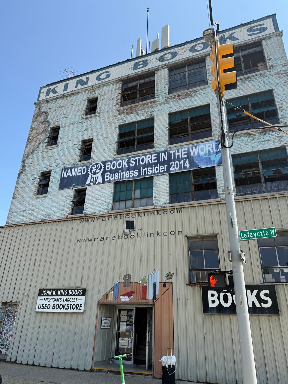 photo of John K. King Used Books in Detroit, with a street sign reading Lafayette W in the foreground