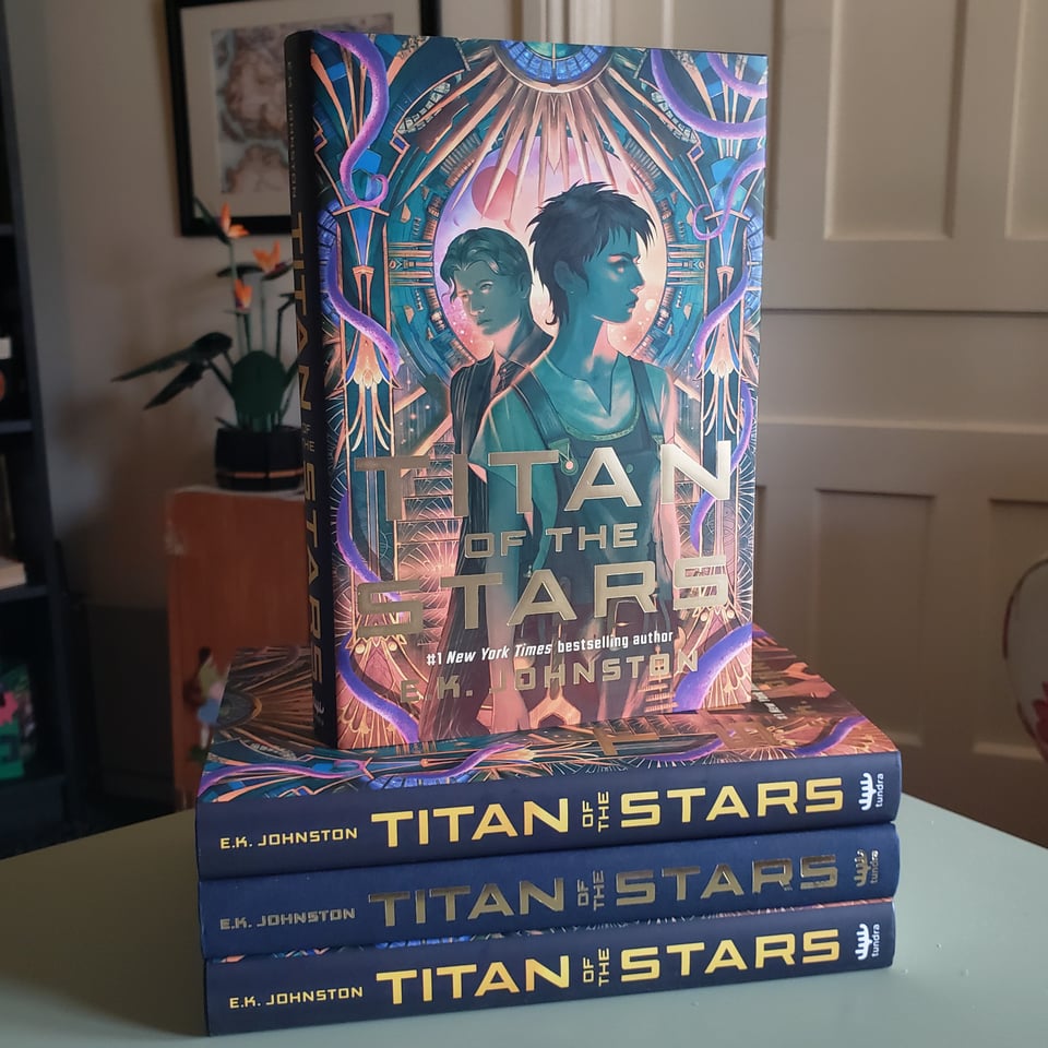 a stack of EK Johnston's Titan of the Stars