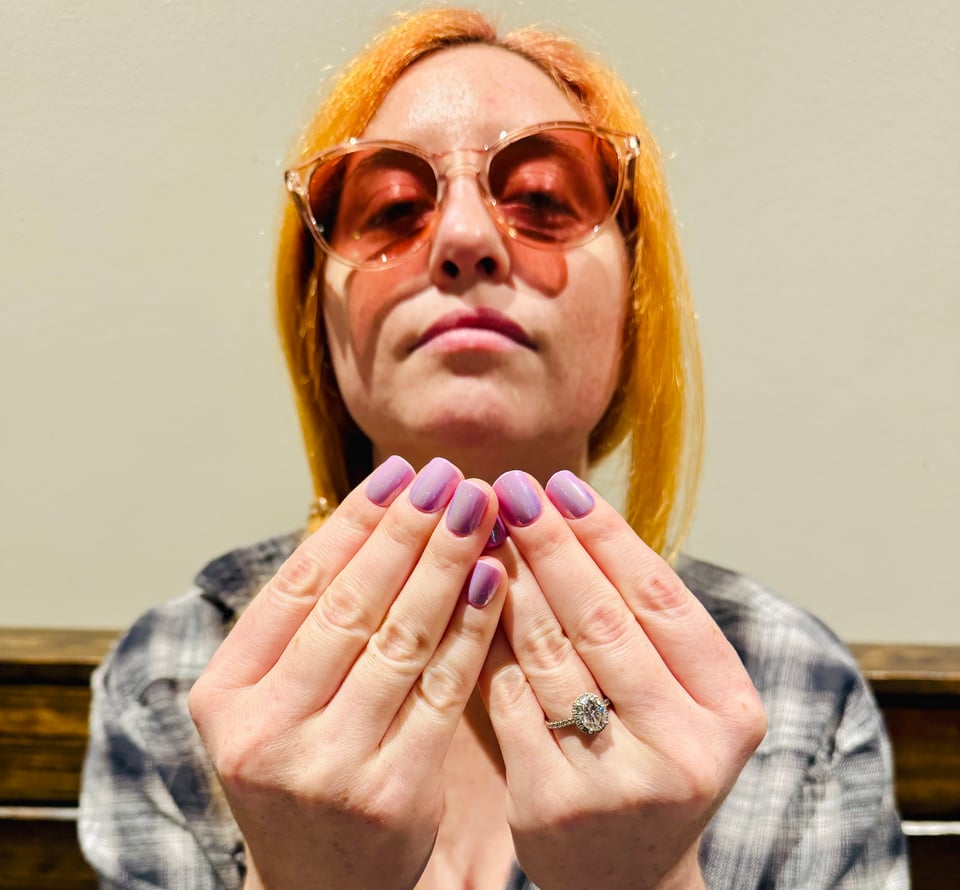 A woman holding an invisible poker hand.