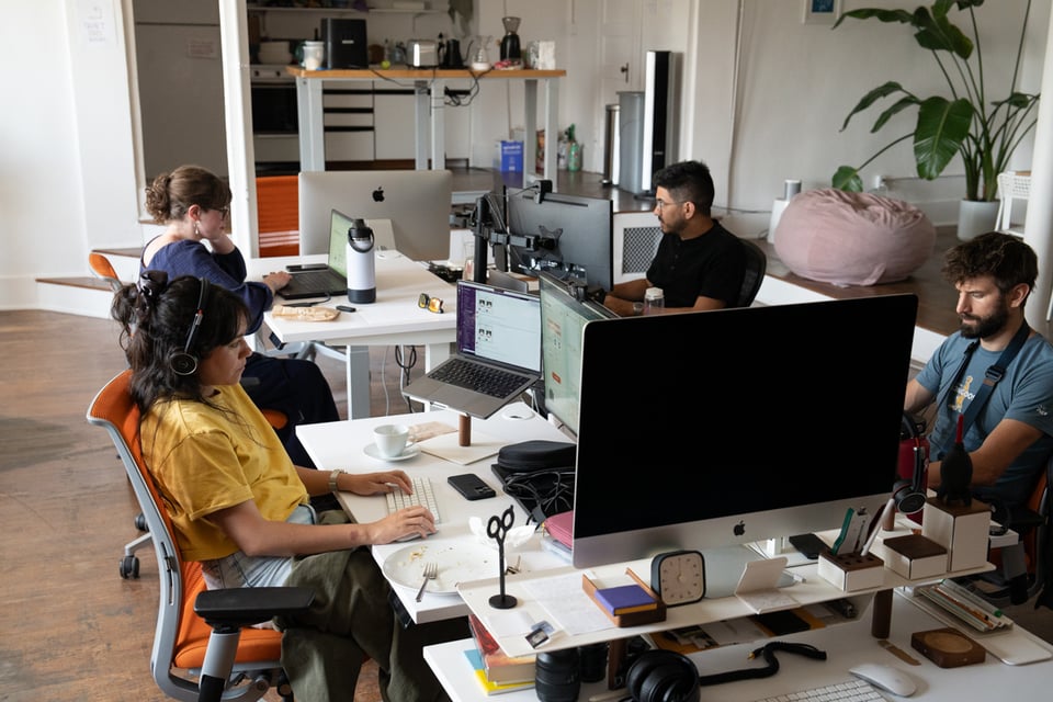 A group of people sitting at desks.