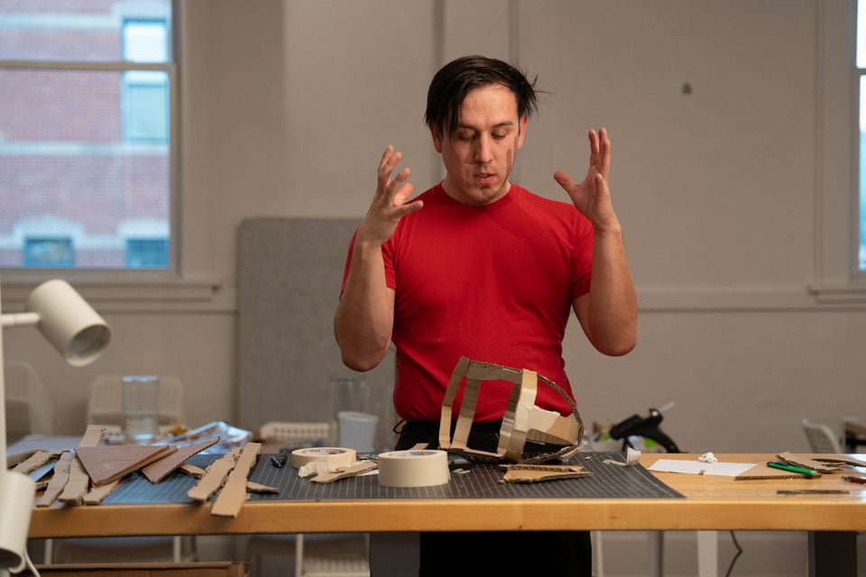 Dan looking at some cardboard taped together.