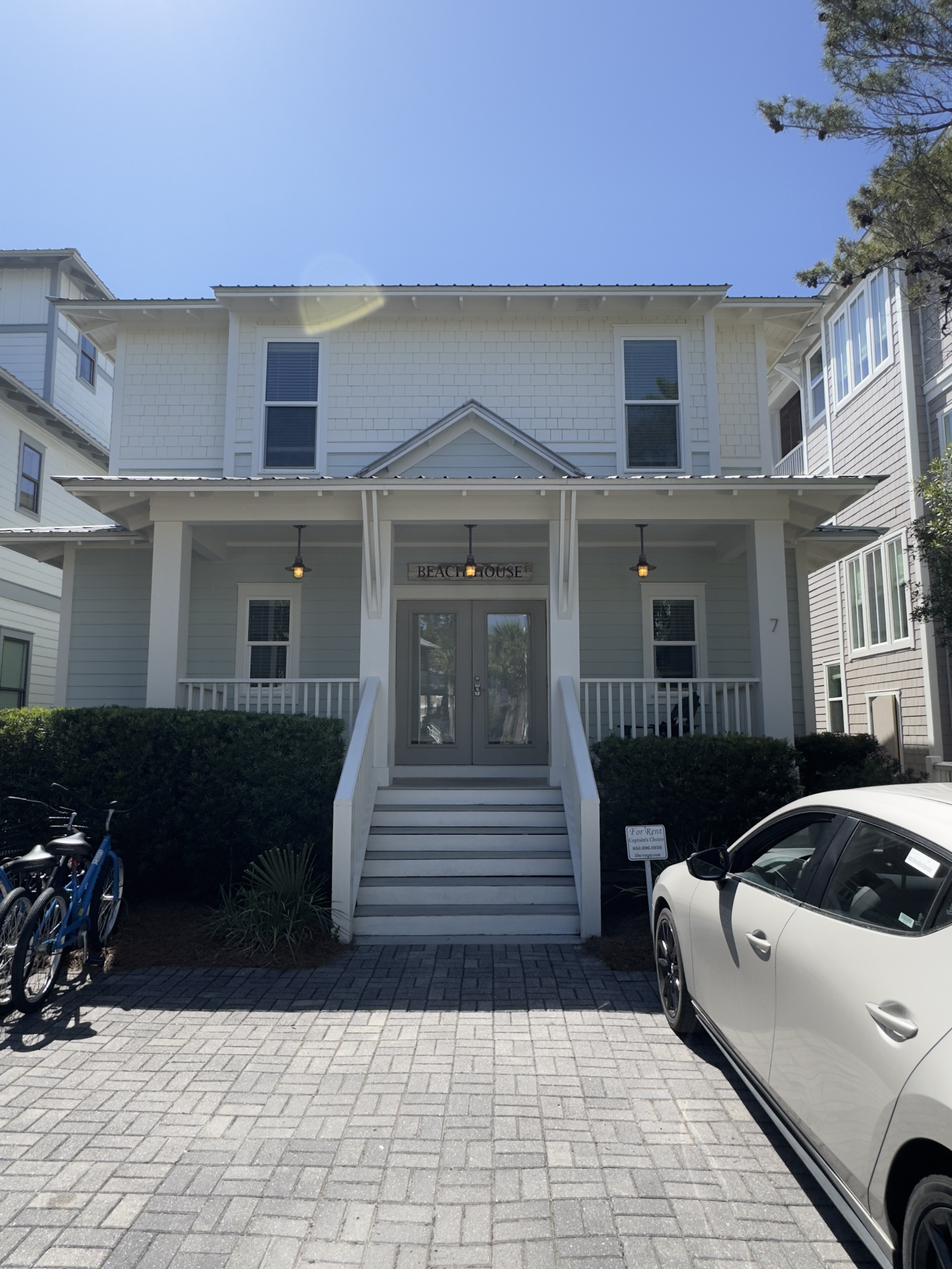 Vacation house with silver car and bikes in the driveway