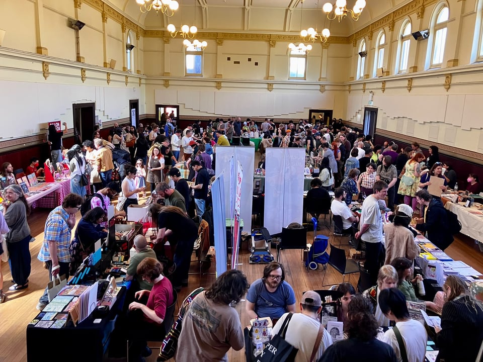 The Kensington Town Hall busy and full with crowds of people browsing tables laden with comics, prints and artwork.