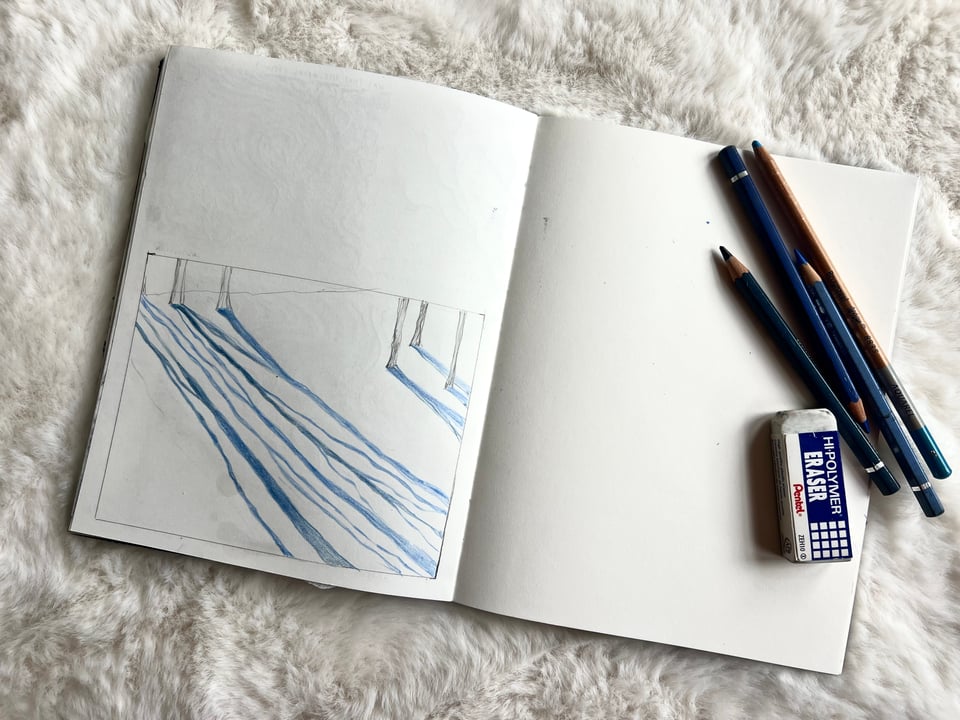 drawing of blue sun shadows on sketchbook