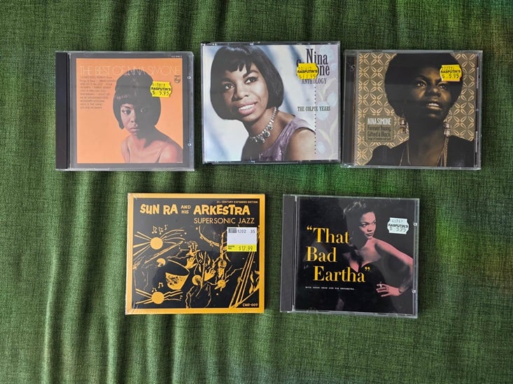 Five used music CDs The Best of Nina Simone, Nina Simone Anthology The Colpix Years, Nina Simone Forever Young Gifted and Black, Sun Ra and His Arkestra Supersonic Jazz, and Eartha Kitt That Bad Eartha