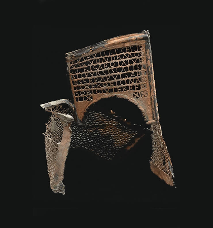 A twisted old, intricate carved metal dice box