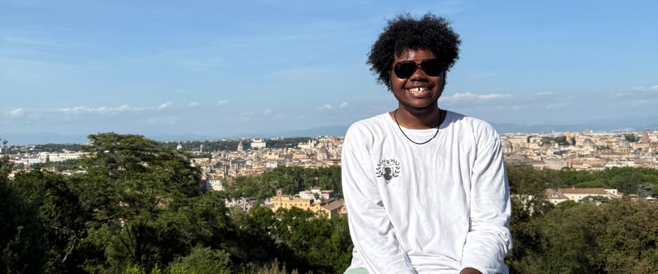 Photo shows Madison student Sammy Leggett during his travels abroad in Italy. He is smiling to the camera and wearing dark sunglasses.