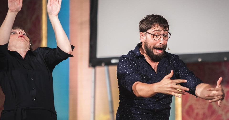 Gael and Laura pulling silly faces on stage.