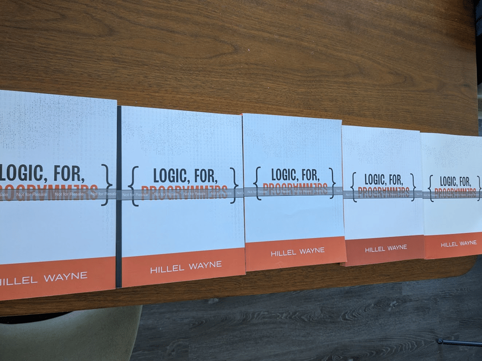 A table filled with five printed LfP proofs