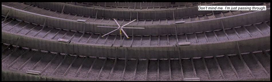An upside down view of an airplane hanger. Text reads: "Don't mind me. I'm just passing through."