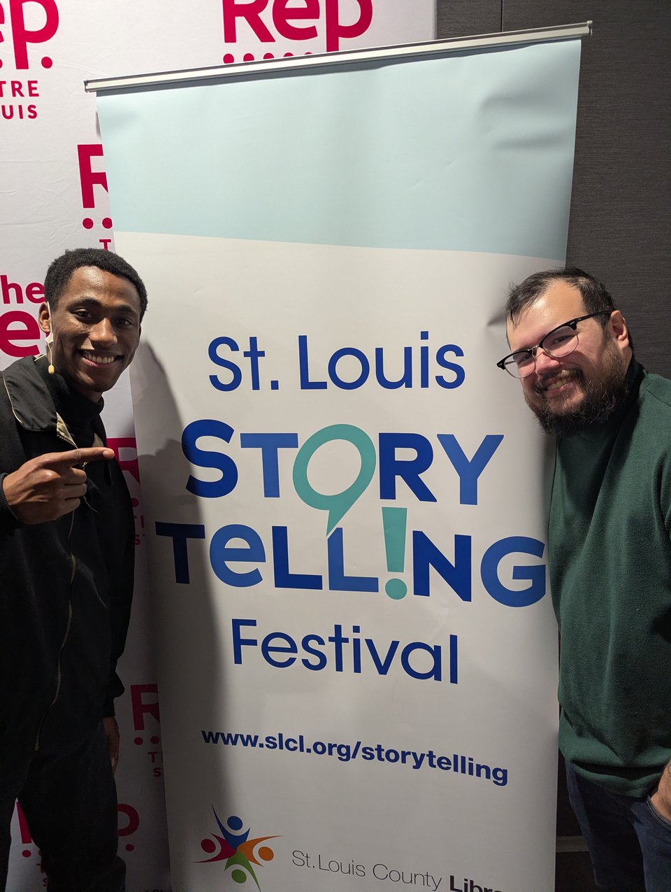 DeAnté Bryant (left) and Mikkel Snyder (right) posing in front of the St. Louis Story Telling Festival banner.