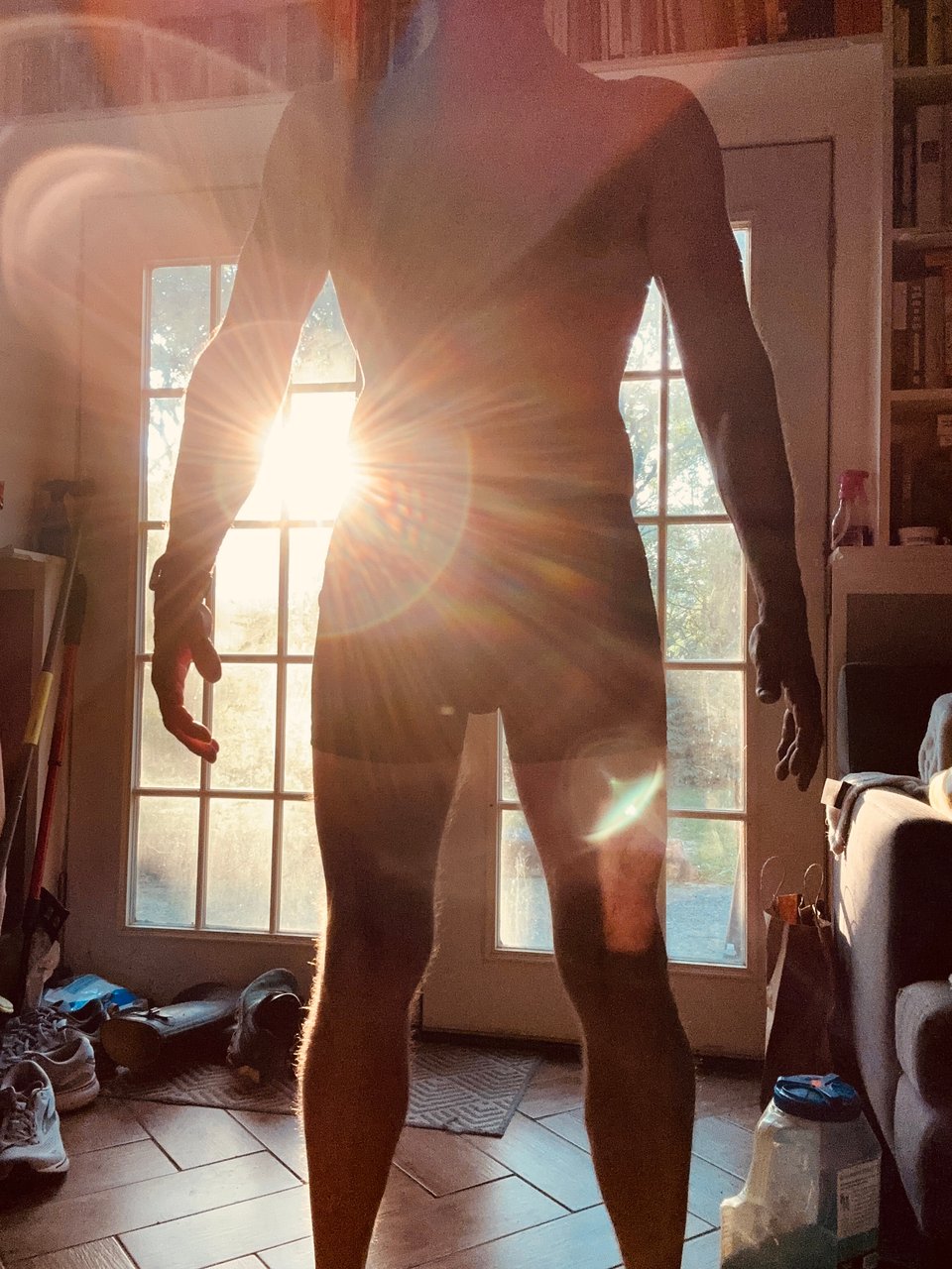 Photo of man in underwear, with lens flare behind him that causes a lot of silhouetting