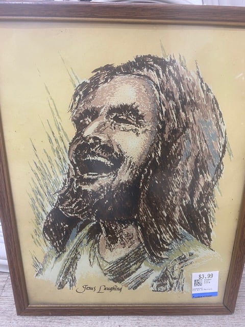 A drawing of "Jesus Laughing" in a cheap wood frame with a $3.99 price sticker