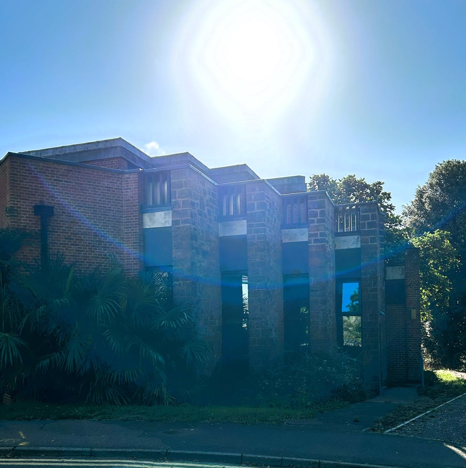 A series of staggered bays with rubblestone walls and windows inset into one side only. There is a huge, huge lensflare.
