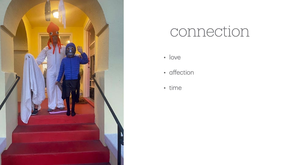 Slide from a presentation on reading to your deaf child. Image: A father, wearing a white jumpsuit and organge squid hat, stands on a porch with his two sons, dressed as a ghost and Day of the Dead skeleton. Text: Connection: love, affection, time.