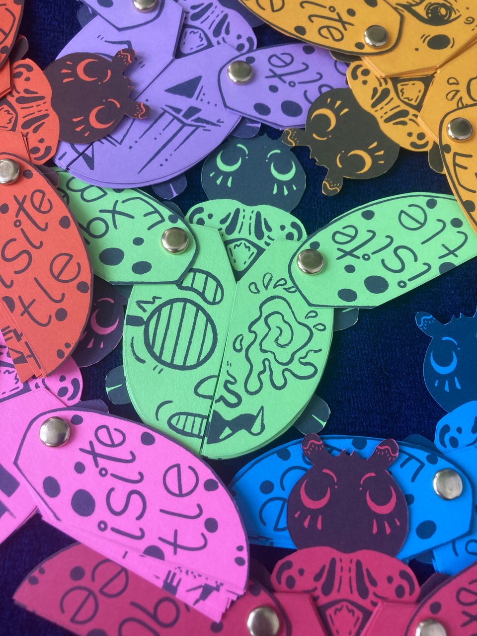Pile of colorful beetle zines