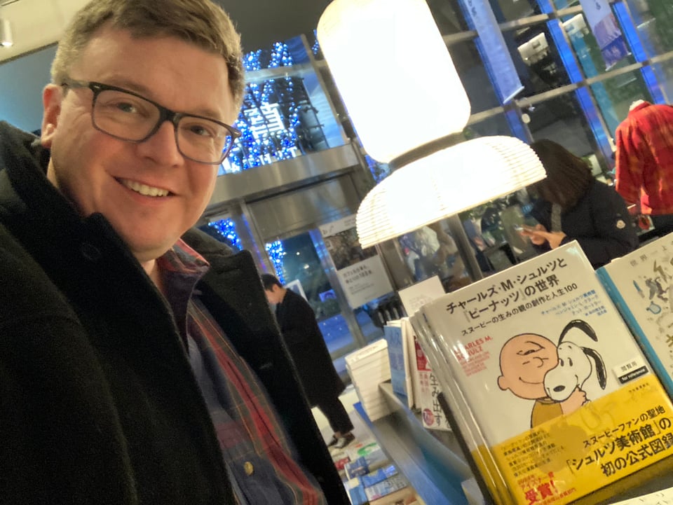 The author takes a selfie with the Japanese translation of a book he co-authored in a bookshop in Tokyo