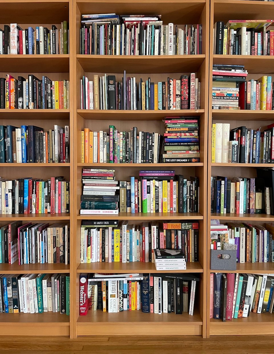 three of the four bookshelves filled with books