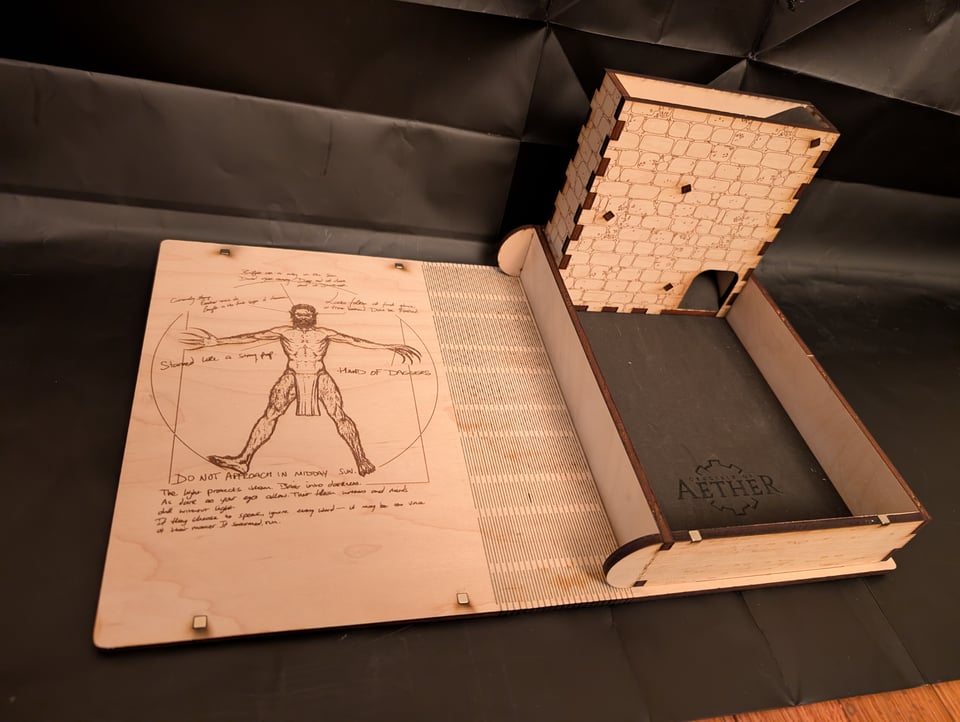 A photo depicts a dice tower for TTRPG Crucible of Aether