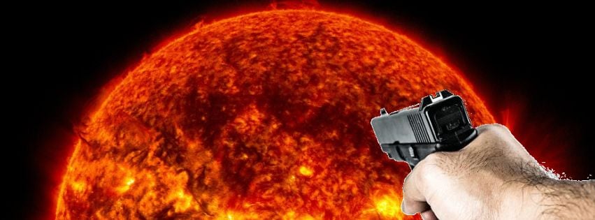 Hand with a gun aimed at the sun in space