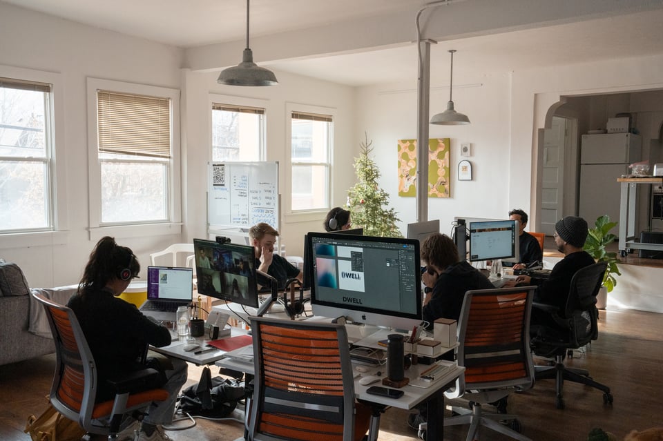 A group of people sitting around desks.