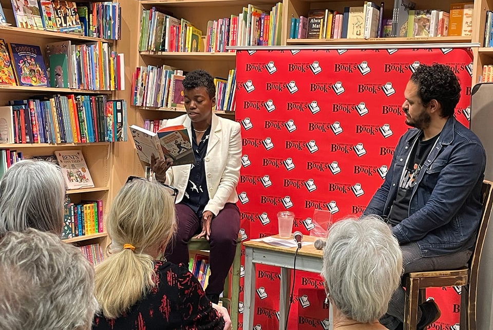author Phoebe Sinclair reads from her novel in a bookstore