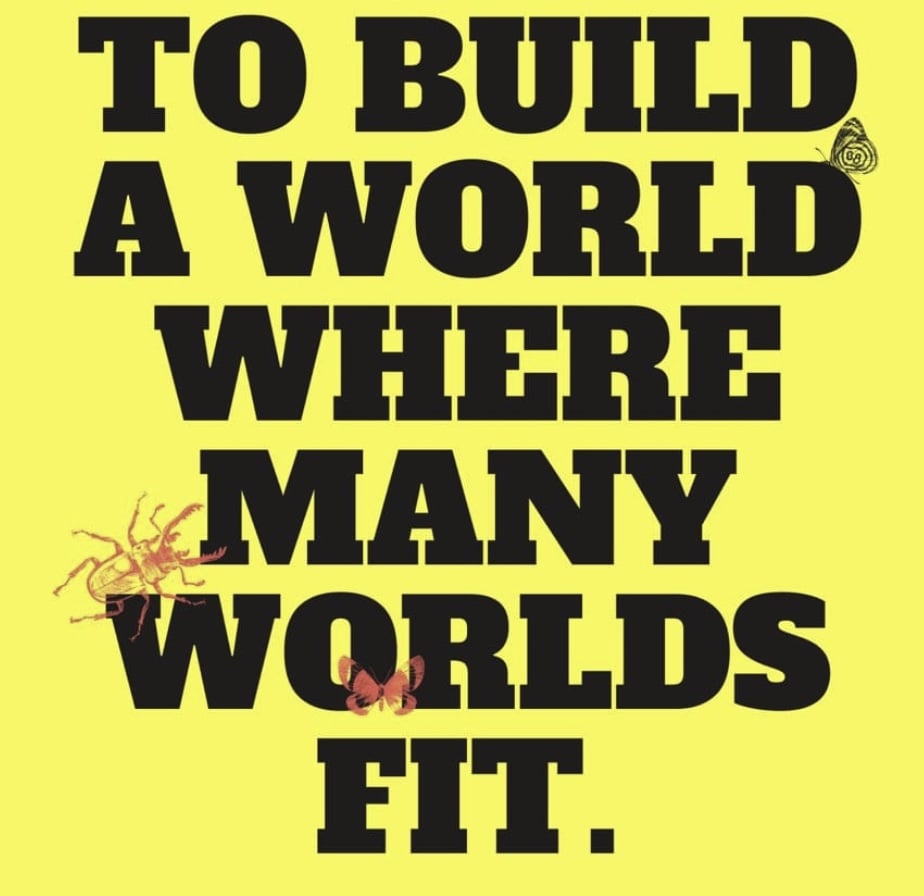 A yellow poster with black serif writing on it that says "A world where many worlds fit", with some prints of creatures from the natural world climbing around