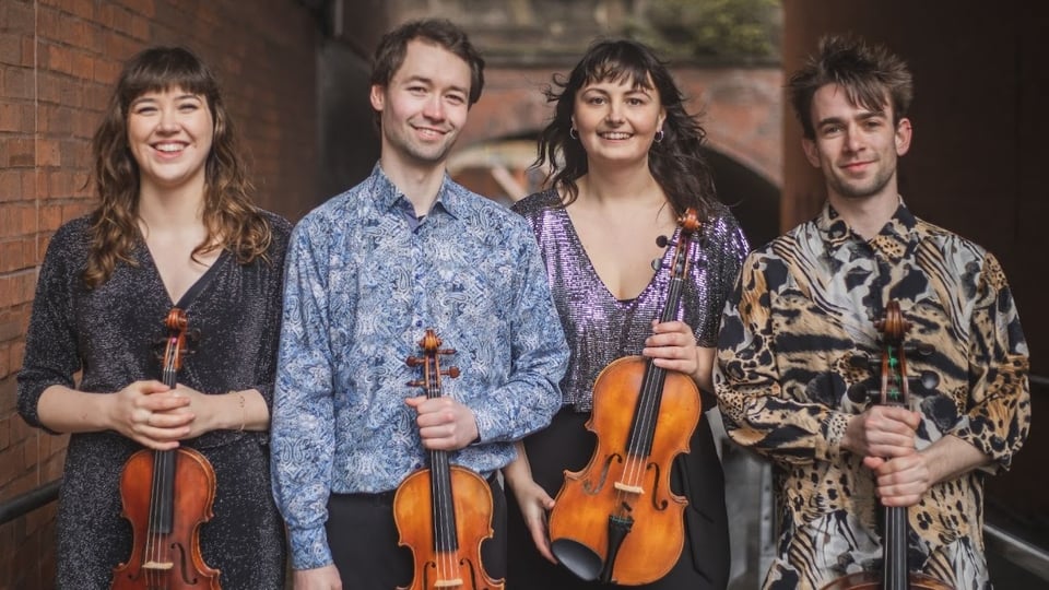 Four performers holding their instruments
