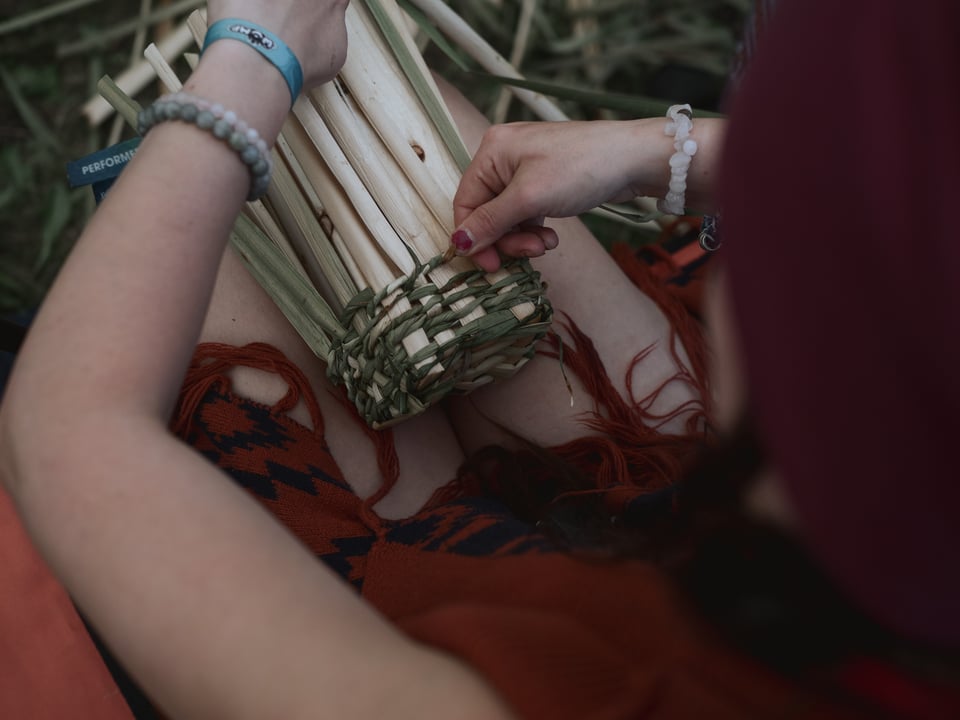 A cattail berry basket part way through weaving
