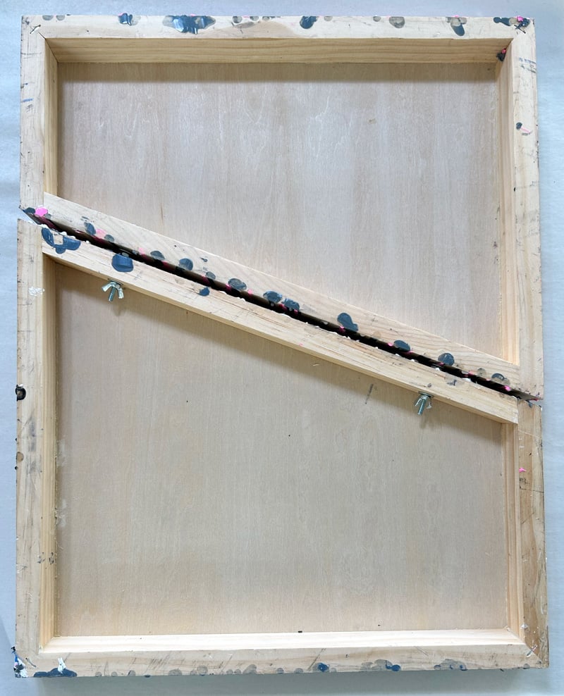 The back side of a painting. Two wooden panels cut at a diagonal, bolted together. Wax drips coming down the sides.