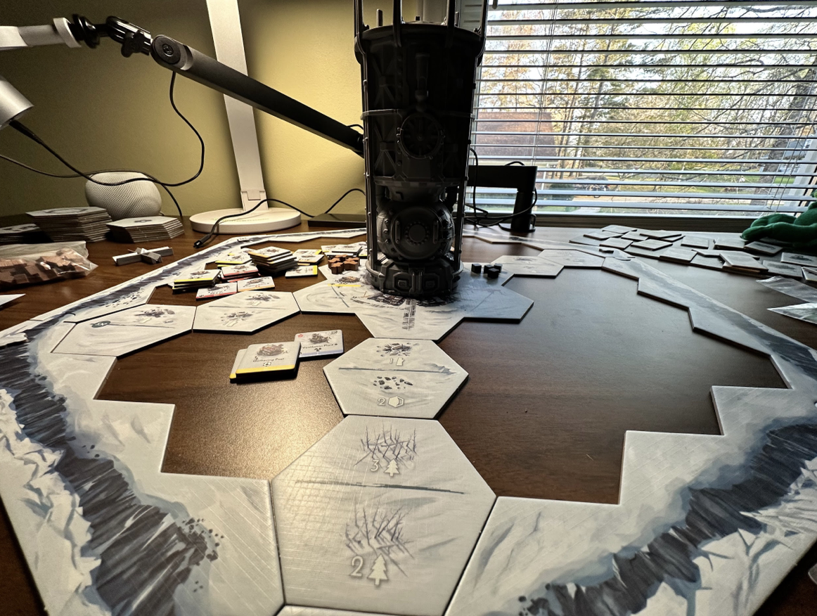 Frost punk tiles on a table with a large tower in the middle.