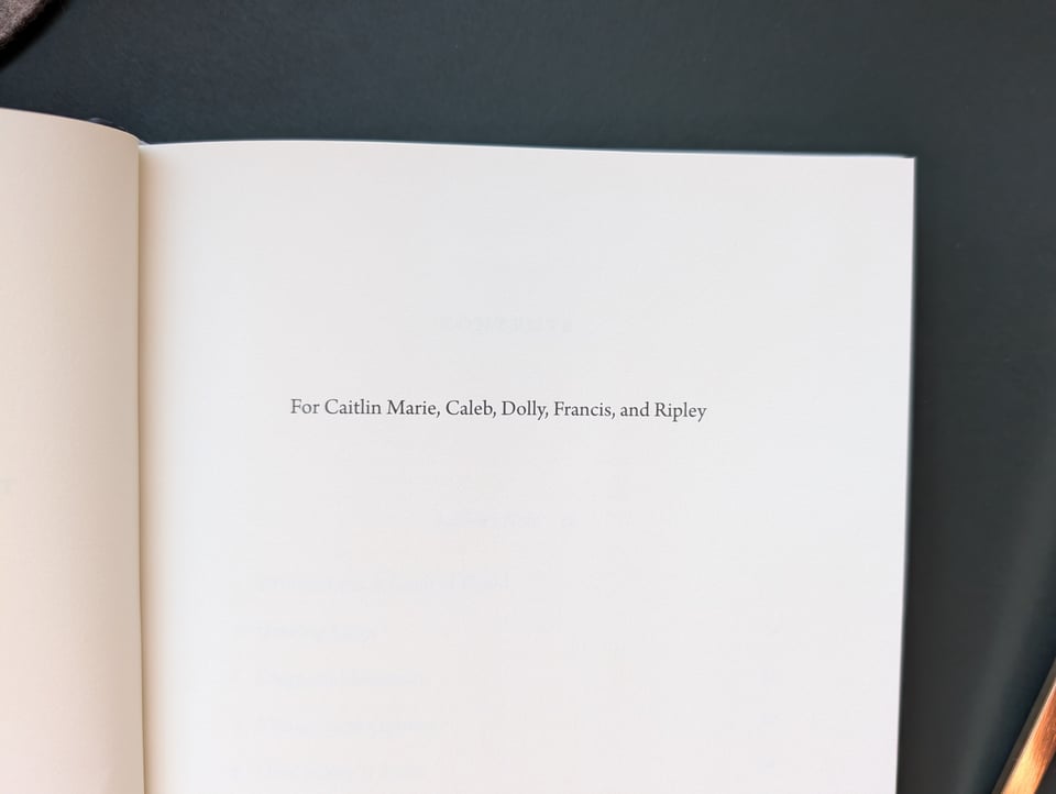 A photograph of the dedication page of Pregnancy Interrupted. It reads “For Caitlin Marie, Caleb, Dolly, Frances, and Ripley”