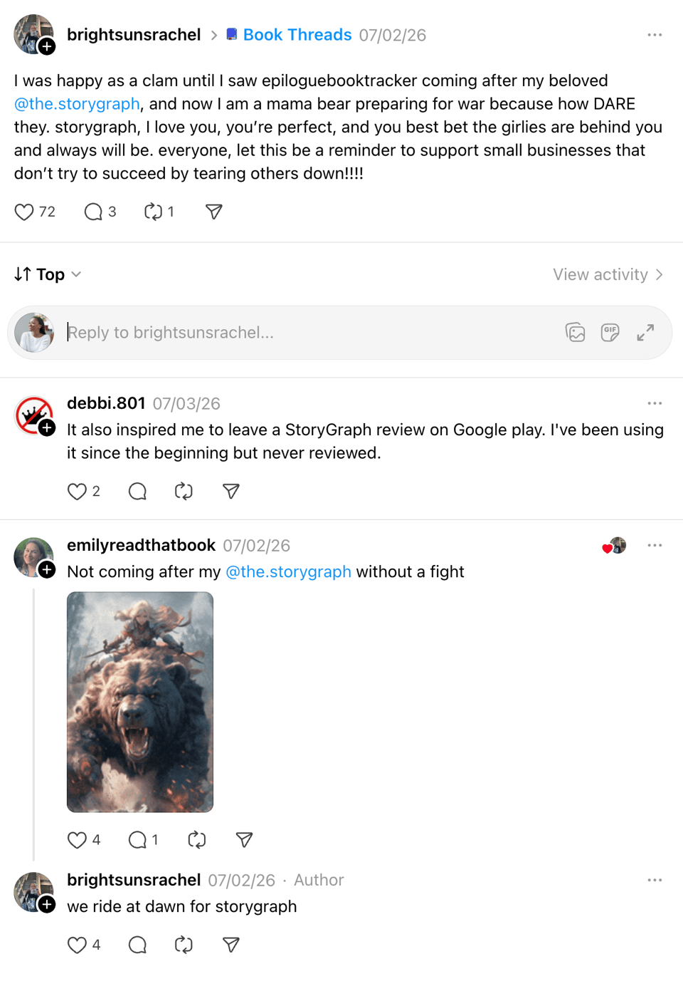 Screenshot of several Threads posts reacting to criticism of The StoryGraph. One user says they're ready to defend StoryGraph, encourages supporting small businesses, and another shares a fantasy image of a warrior riding a bear with the caption, "Not coming after my @the.storygraph without a fight." A reply adds, "we ride at dawn for storygraph."