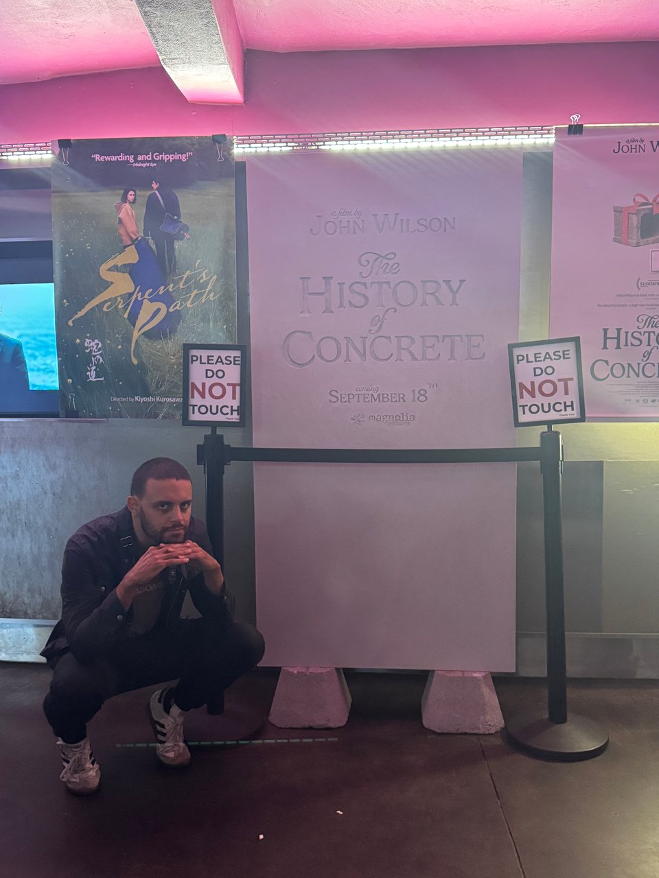 me standing next to the slab poster for The History of Concrete at IFC Center.