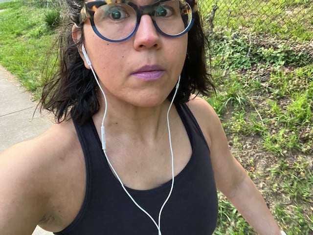 a woman wearing glasses and earphones