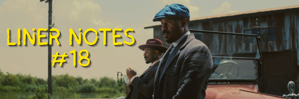 An official still from the film Sinners; the Smokestack Brothers, two Black men played by Michael B. Jordan, are in the foreground, with the text "Liner Notes #18" to their left. In the background is their car, part of a building, and the sky, trees, and an electricity pole.