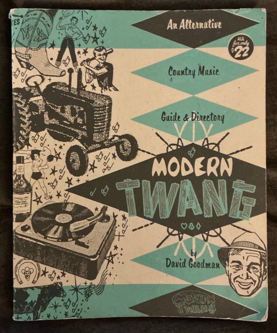 Photograph of the cover of a large, softcover book: a 1960s style design with a bunch of retro illustration art of a cow, a record player, a tractor, a man’s face, etc. there’s a title reading MODERN TWANG By David Goodman And above the title it says An Alternative Country Music Guide & Directory