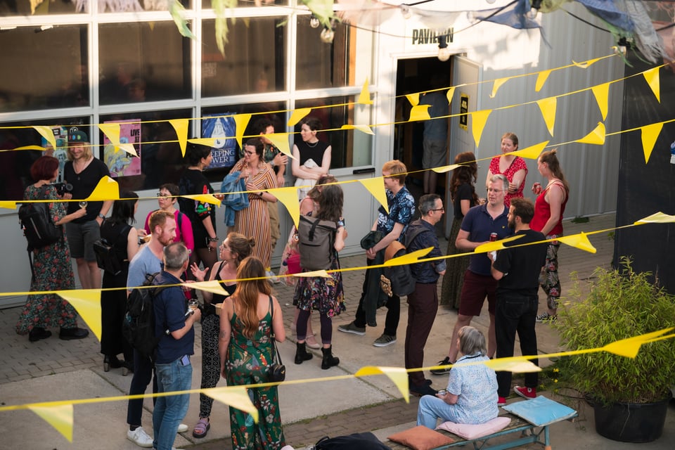 Crowd outside of the venue at the Flock Festival 2024, and yellow flags