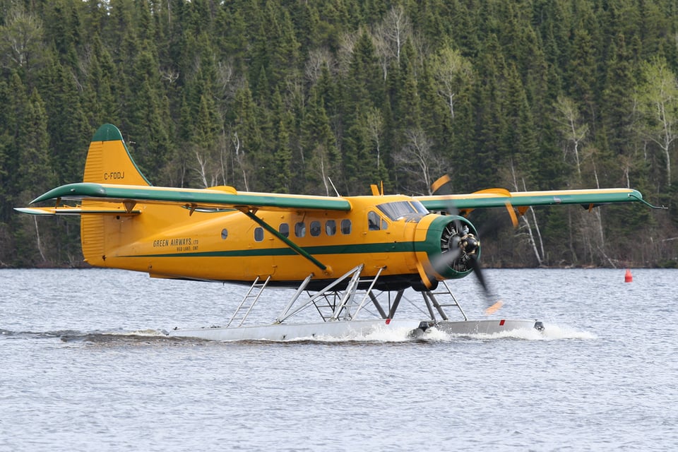 de Haviland Otter float plane taxiing on water.