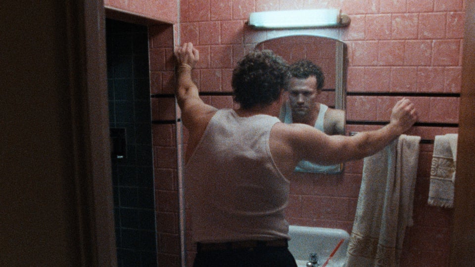 Henry (Michael Rooker) looks into the bathroom mirror in Henry: Portrait of a Serial Killer