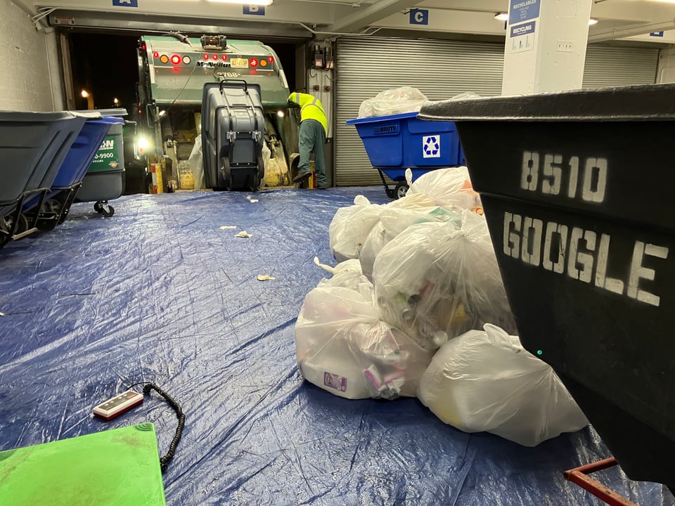 carting guys throwing trash and recycling bags into the hopper of a truck, google printed on a cart