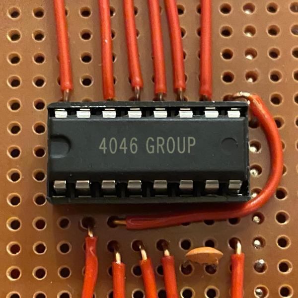 The image used by 4046 Group. It shows an integrated circuit on perfboard, with wires coming out of the pins.