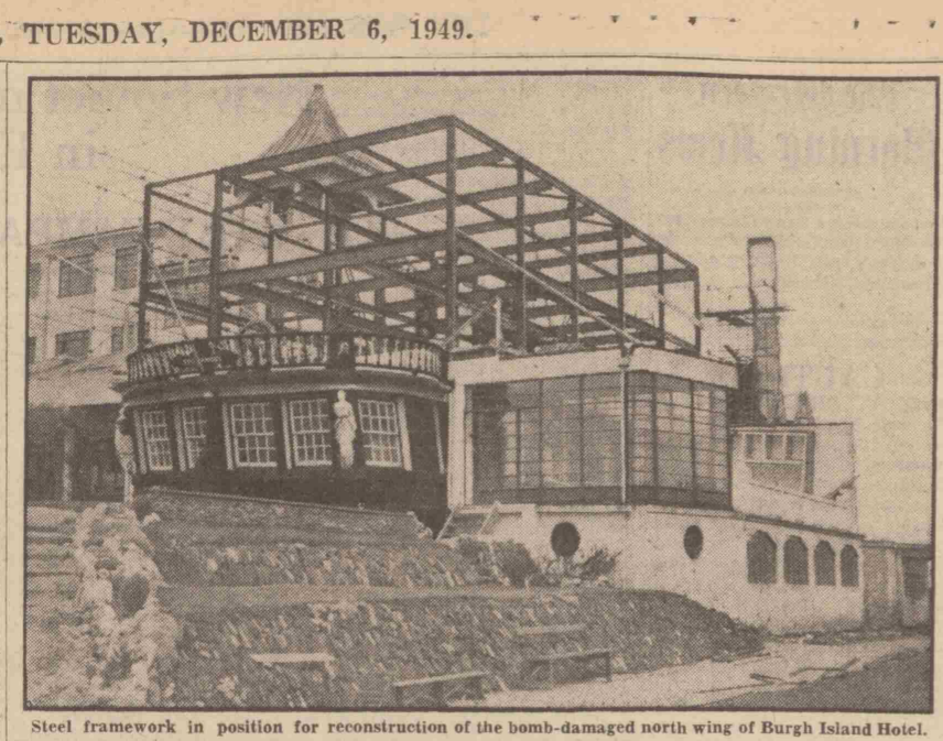 Photo of the steel frame of the reconstruction. The frame rises two storeys over the stern of the HMS Ganges. To the right of the image, the orginal lower ground floor of the eastern wing is visible and shows it was made with porthole windows. To the left, the glass roofs of the palm court are just visible.