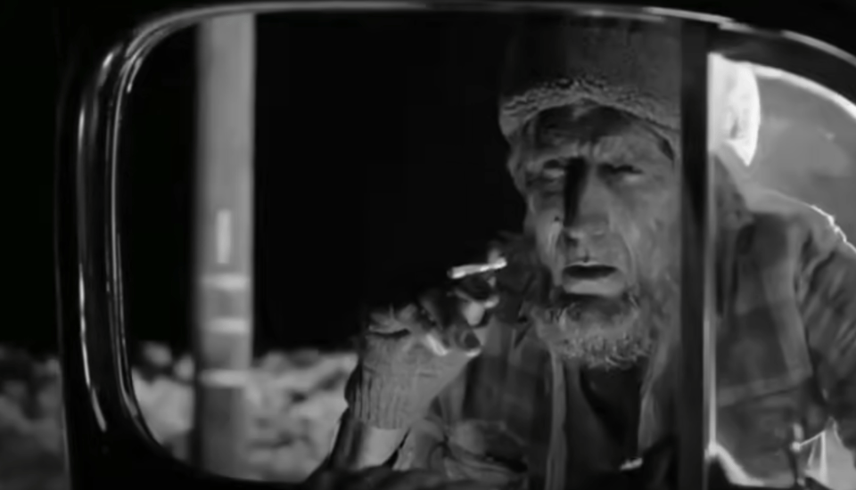 Screenshot from Twin Peaks season 3, the mysterious woodsman asking for a light