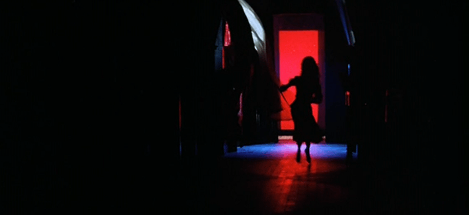 Suzy Bannion from the 1977 horror film Suspiria flees down a hallway