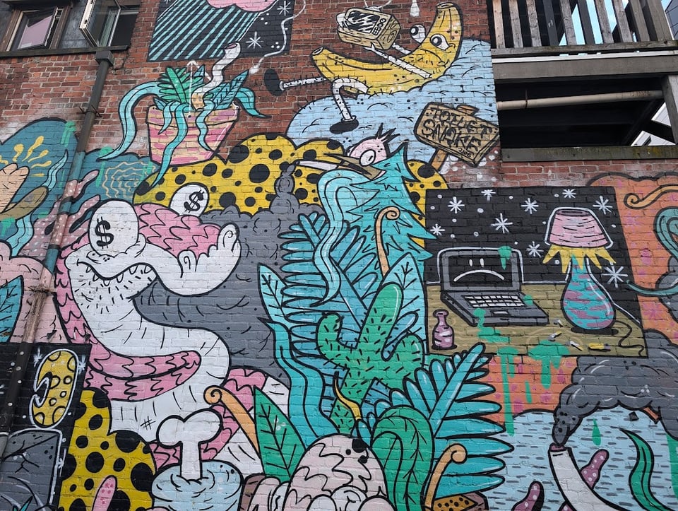 A snake with dollar sign eyes and a sign saying TOILET SNAKE. Plus weird vegetation, a spotted yellow cloud, a laptop with a frowny face against a night sky, and puffy weird images.