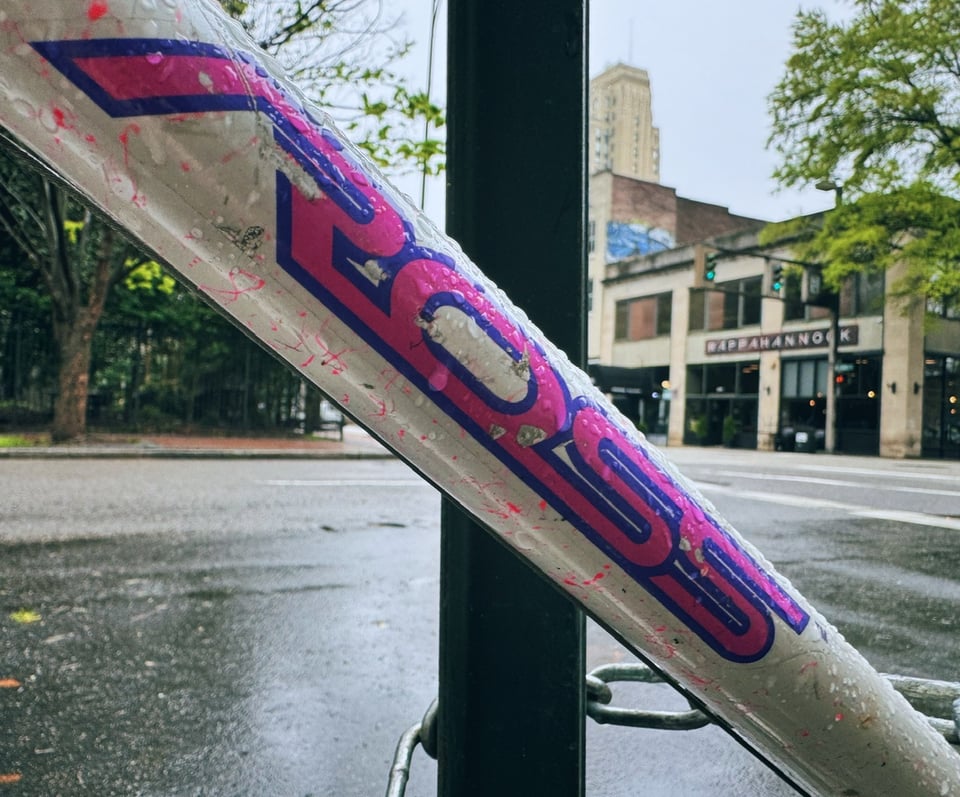 a bike with the word ross on it, written in the most 90s of pink