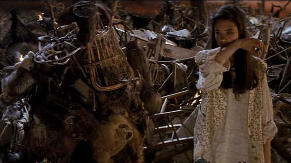 Scene from the film Labyrinth (1986). A puppet character covered in junk stands next to Sarah in a junk yard outside of the Goblin City.